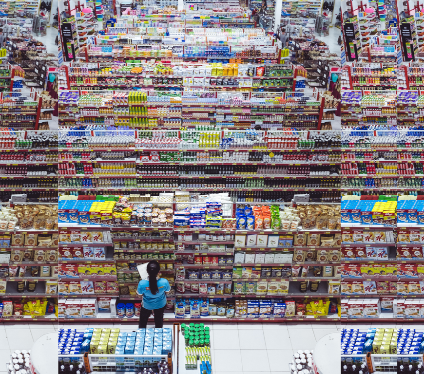 A woman reads labels in a large grocery store